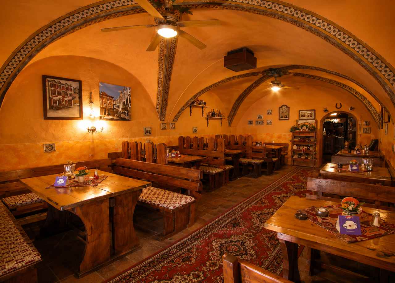 Restaurant Bohemina at Mini Hotel Abraka with vaulted ceilings and warm wood seating